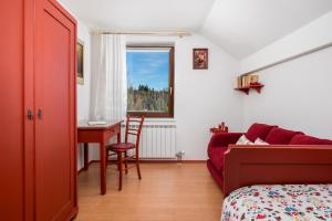 a bedroom with a bed and a table and a desk at Holiday Home & Spa Kozji Vrh in Čabar