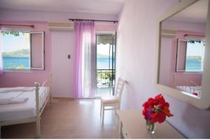 a bedroom with a bed and a table with a mirror at Giorgio Apartments in Nikiana