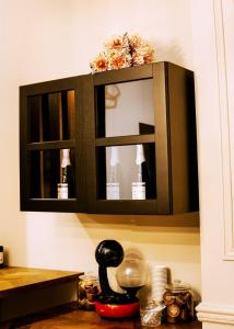 a cabinet with a mirror above a kitchen counter at Aslyra in Liège