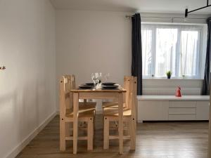 a table and chairs in a kitchen with a window at Lovely 2 Bed flat close to South Woodham Ferrers station in Woodham Ferrers