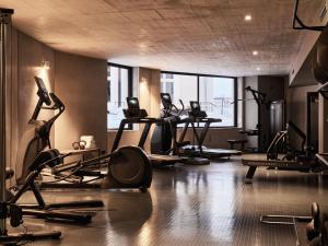 a gym with several tread machines in a room at Badeschloss in Bad Gastein