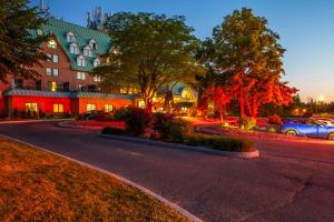a street in front of a building with cars parked at Chateau Cartier Hotel & Resort Ascend Hotel Collection in Gatineau