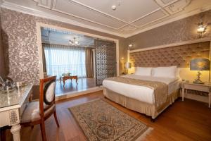 a hotel room with a bed and a desk and a room at The Central Palace Taksim in Istanbul