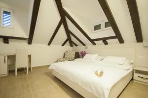 Un pat sau paturi într-o cameră la Hotel Konavle