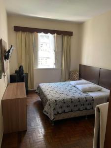 a bedroom with a large bed and a window at Brasil Palace Hotel in Belo Horizonte +37 photos