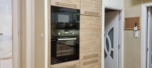 a kitchen with an oven with a tv in it at Bulb Apartment Budapest in Budapest