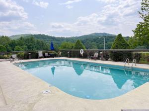 a swimming pool with a view of the mountains at Cherokee Inn in Cherokee