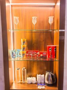 a cupboard with a bunch of items in it at The Vacation Villa in Agra