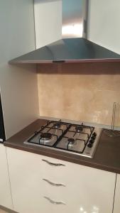a stove top in a kitchen with a hood at Apartment Orloj in Primo&scaron;ten