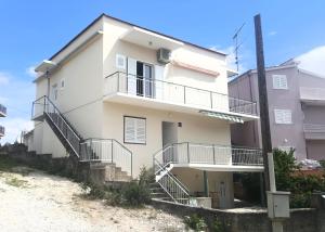 a white house with stairs in front of it at Apartment Orloj in Primo&scaron;ten
