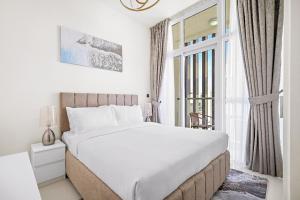 a bedroom with a large bed and a window at Aliving Luxury 3BR Villa With Maid Room Damac Hills 2 in Dubai