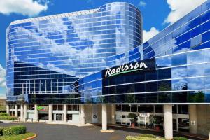 a building with a sign on the side of it at Radisson Hotel Vancouver Airport in Richmond