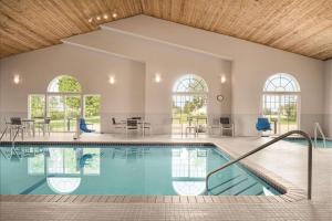 a large swimming pool in a home with a large ceiling at Country Inn & Suites by Radisson, Pella, IA in Pella