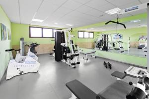 a gym with treadmills and machines in a room at Elba Lucía Sport & Suite Hotel in Costa de Antigua