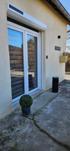 a potted plant sitting in front of a door at Loft Détente & Spa du Tram in Ronchamp