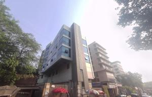 a tall building on the side of a street at Hotel Beverly Palace Santacruz - Near BKC - Mumbai Airport T1 in Mumbai