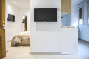 Televízia a/alebo spoločenská miestnosť v ubytovaní Apartamentos Sudestada
