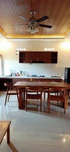 a large kitchen with a wooden table and chairs at Villa Ole in Ubud