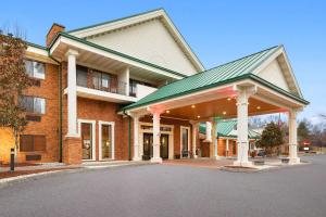 a large brick building with a green roof at Country Inn & Suites by Radisson, Jonesborough-Johnson City West, TN in Jonesborough