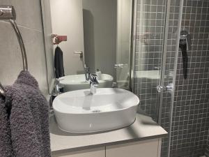 a bathroom with a sink and a shower at Trendy Apartment in Durban