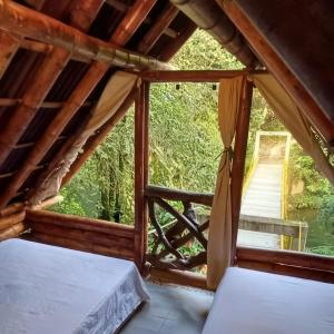 a room with a bed and a window at Cabaña Eco-Río Cristalino/Hamacas/Fogata in San Francisco
