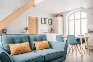 a living room with a blue couch and chairs at The Old Granary in Barnetby le Wold