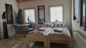 a bedroom with a bed and a christmas tree at U Bieńka in Biały Dunajec