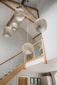 a room with several lights hanging from the ceiling at The Old Granary in Barnetby le Wold