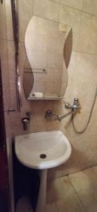 a white sink in a bathroom with a mirror at Санаторій Збруч in Satanov