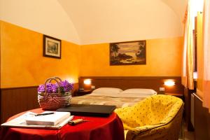 a hotel room with a bed and a table with a laptop at Hotel Antica Fonte in Brescia