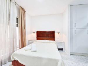 En eller flere senge i et værelse på Alojamientos Fenix