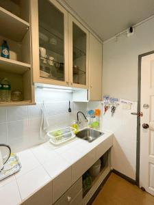 a kitchen with a sink and a counter top at Tower Resident in the Heart of Bangkok Shopping Center in Makkasan