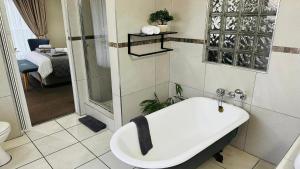 a bathroom with a sink and a shower and a toilet at Plattekloof Premium Lodge in Plattekloof