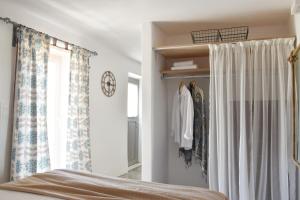 a bedroom with a bed and a window at Koukounari Cottage Apartment Paros in Naousa