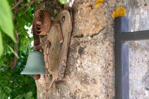 a bell on the side of a stone wall at La Terrade in Saint-Hilaire-La-Treille