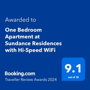 a blue sign that reads upgraded to one bedroom apartment at sunrise reserves with hti at One Bedroom Apartment at Sundance Residences with Hi-Speed WiFi in Cebu City