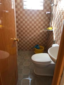 a bathroom with a toilet and a sink at Jaleen Transient in Batangas City