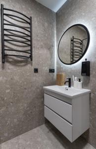 a bathroom with a white sink and a mirror at MYFREEDOM Апартаменти ЖК NAVIGATOR in Kyiv