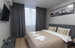 a bedroom with a bed with two towels on it at MYFREEDOM Апартаменти ЖК NAVIGATOR in Kyiv