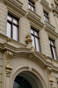 a building with windows on the side of it at The Bank Poznan Apartments in Poznań