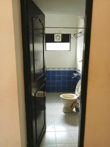 a bathroom with a toilet and a shower with a door at happystay@casablanca2 in Chennai