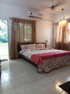 a bedroom with a bed with a red blanket at happystay@casablanca2 in Chennai