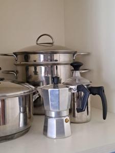 a group of stainless steel pots and pans on a counter at Casa di Gabry in Cento