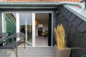 a house with glass doors and a patio at Rooftop Suite Essen Central-Fair-HBF-Uniklinik-Balcony-Walk-In Shower-Coffee station-WiFi-Workspace in Essen