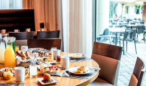 a table with plates of food on it in a restaurant at Queen of Sheba Eilat in Eilat