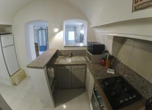 a kitchen with a sink and a counter top at Appartement en pierre à proximité Lourmarin in Lauris