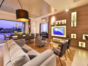 a living room with a couch and a dining room at Villa Formosa in Kaštela