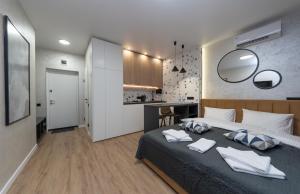 a bedroom with a large bed and a kitchen at MYFREEDOM Апартаменти ЖК NAVIGATOR in Kyiv