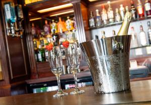 three wine glasses and a champagne bucket on a bar at The Central Hotel in Scarborough