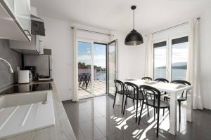 a kitchen and dining room with a table and chairs at Astrid 2 in Rabac